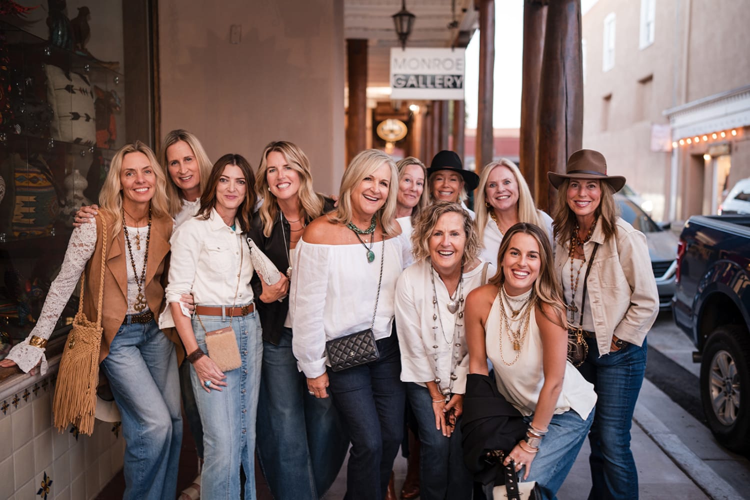 group portrait captures eleven women posed on a historic downtown Santa Fe street lined with adob... — Casey Addason Photography