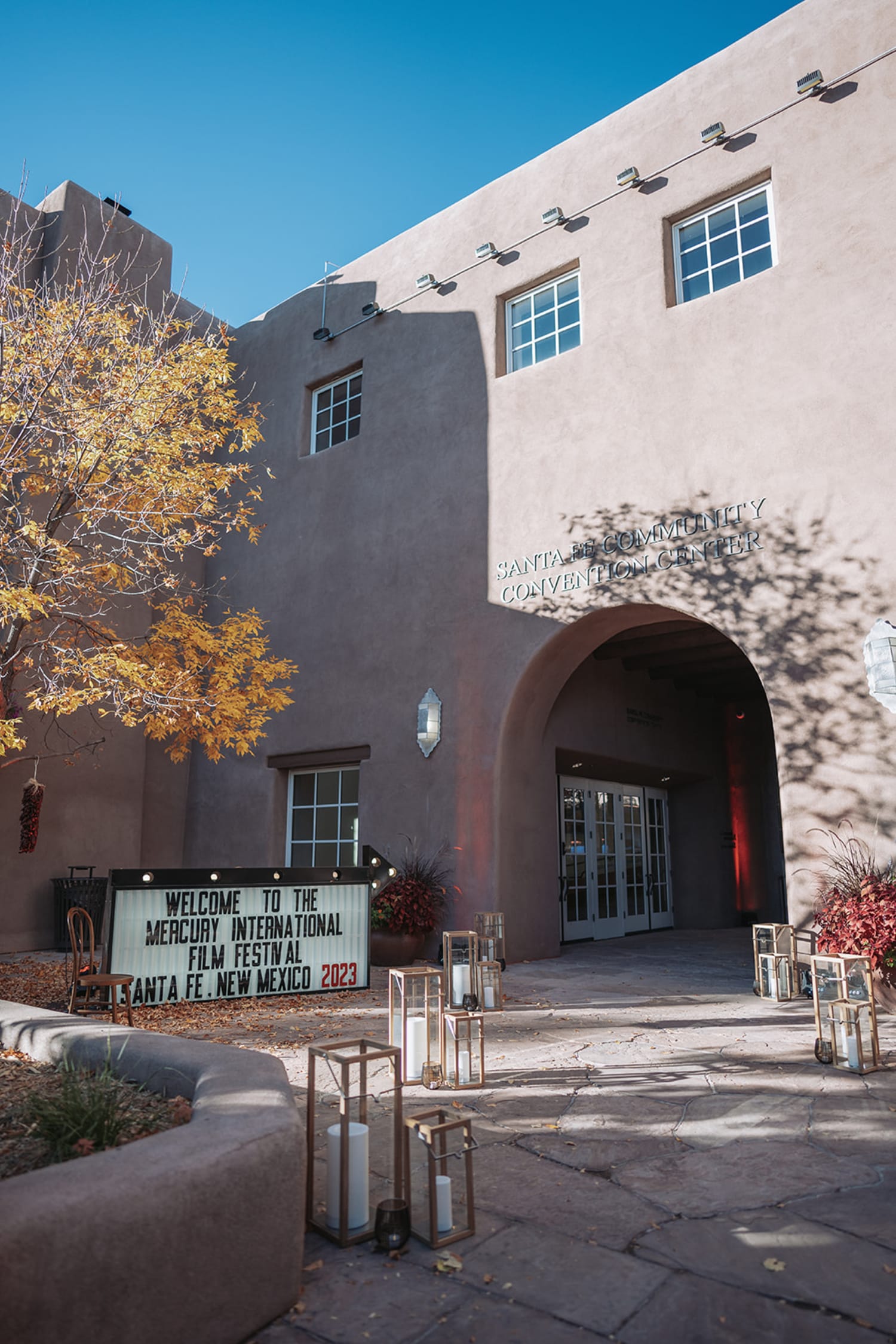 Santa Fe Community Convention Center Pueblo Revival architecture during corporate event, warm golden afternoon light