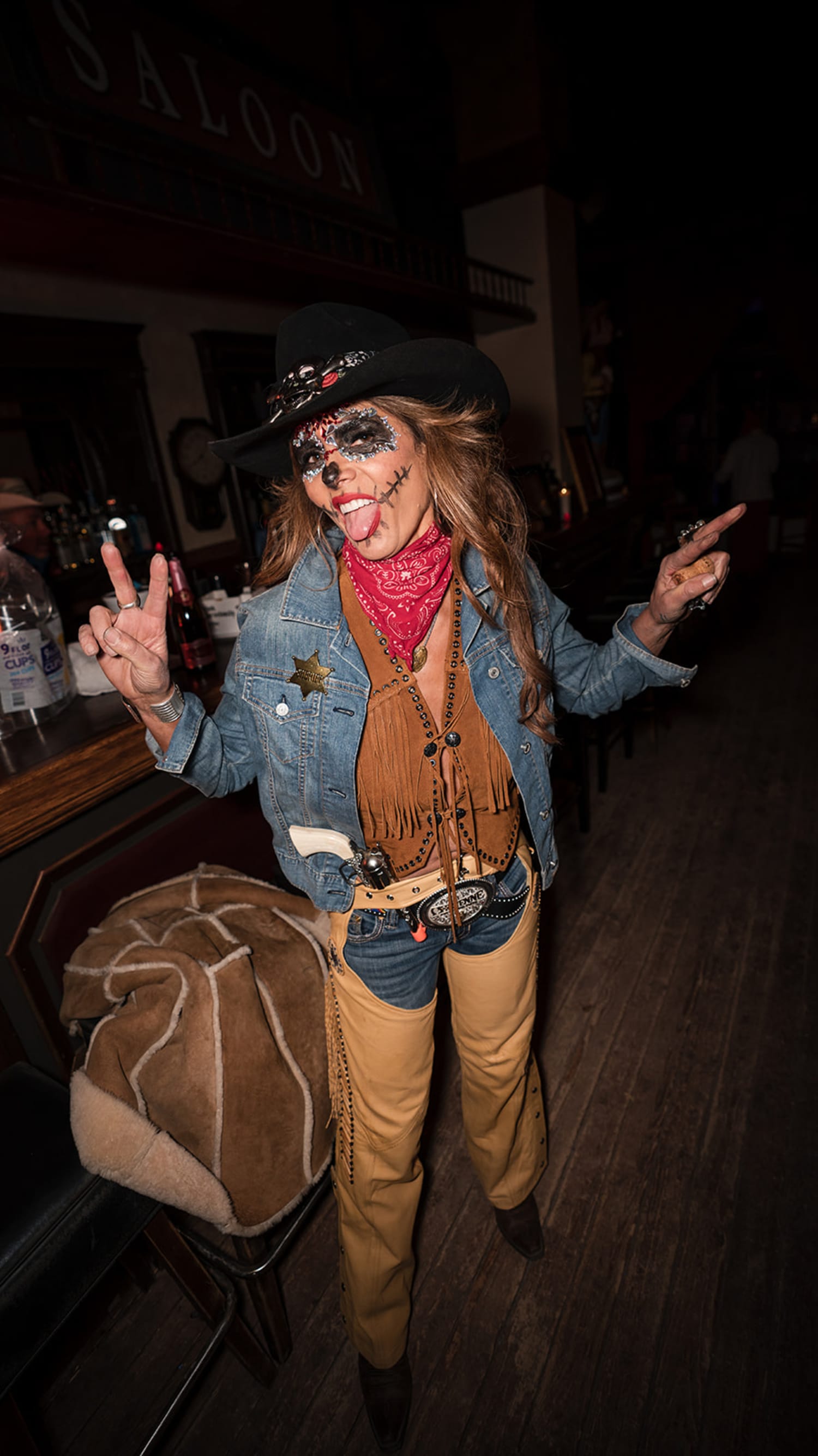 evening event features a guest in an elaborate cowboy costume complete with theatrical face paint... — Casey Addason Photography