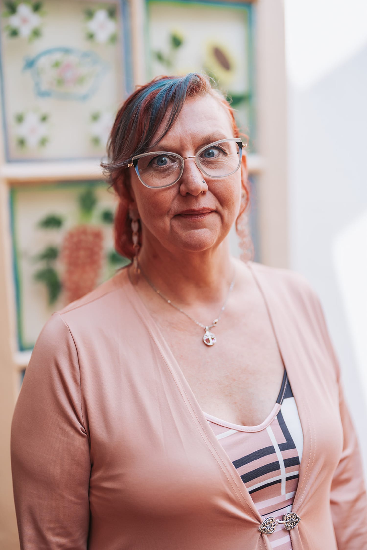 professional portrait photograph taken indoors against a decorative backdrop featuring botanical ... — Casey Addason Photography