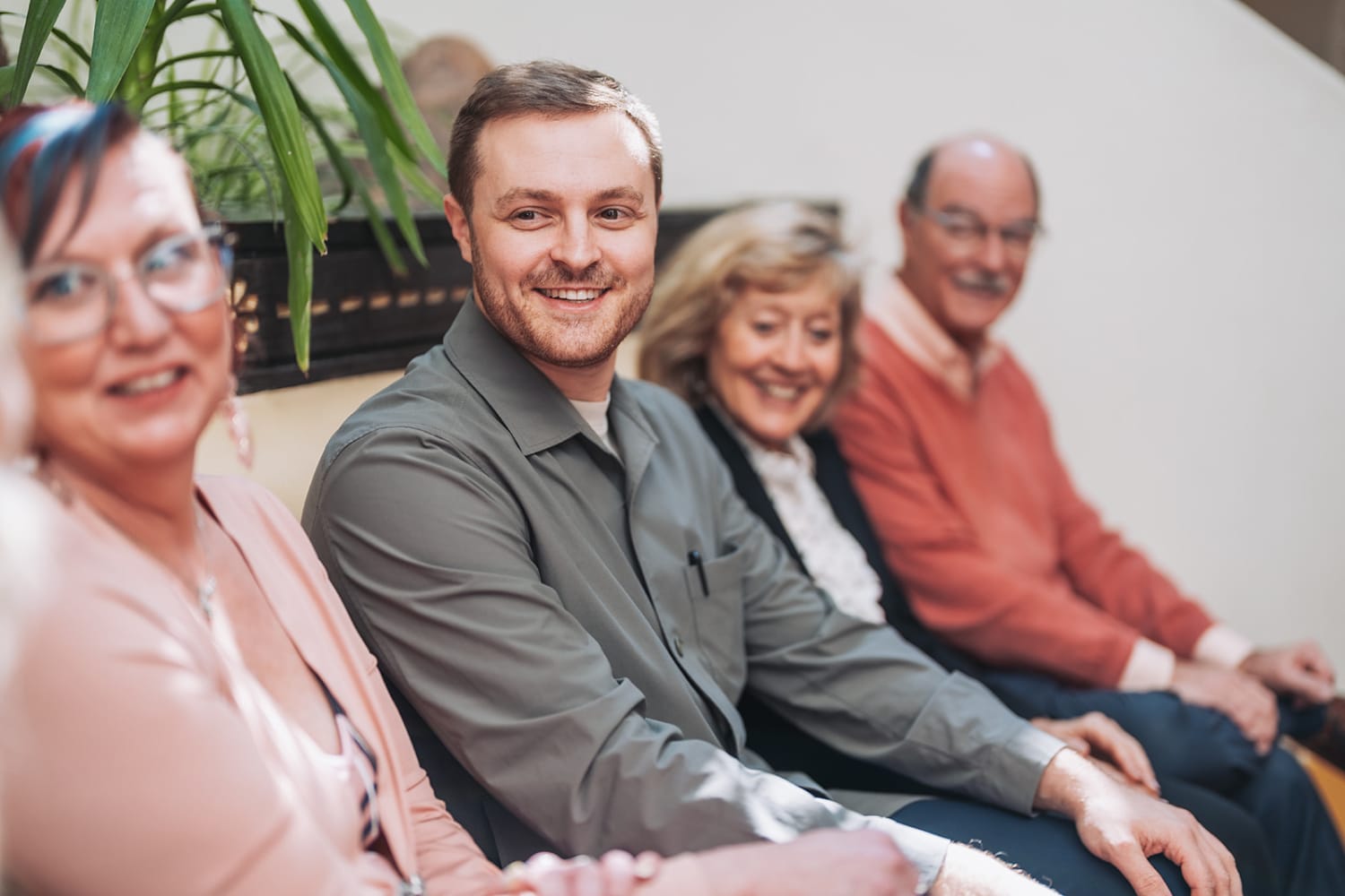 group portrait captures four adults seated together in what appears to be an office or business s... — Casey Addason Photography