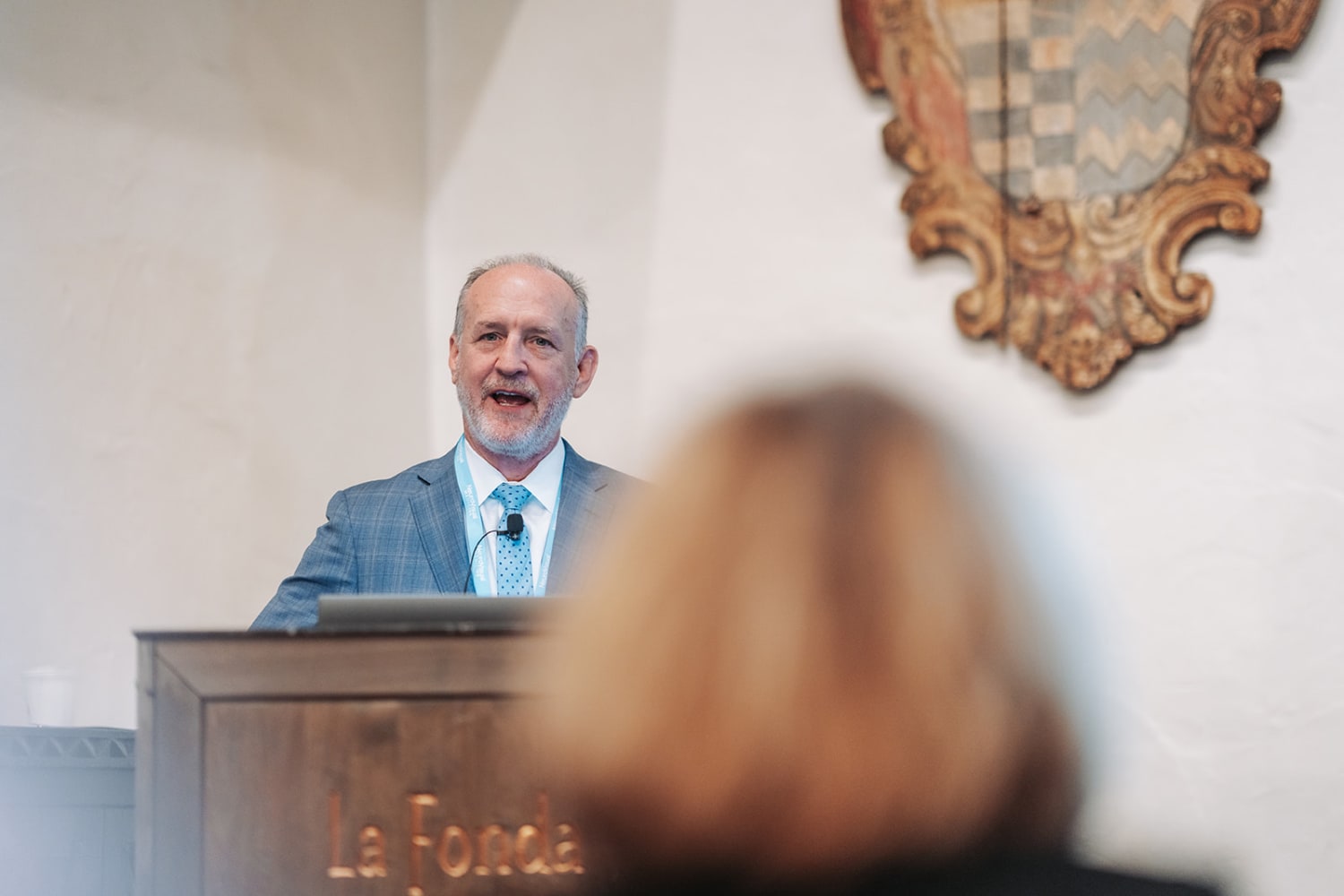 image captures a speaker at an indoor formal event in what appears to be a historic venue, eviden... — Casey Addason Photography