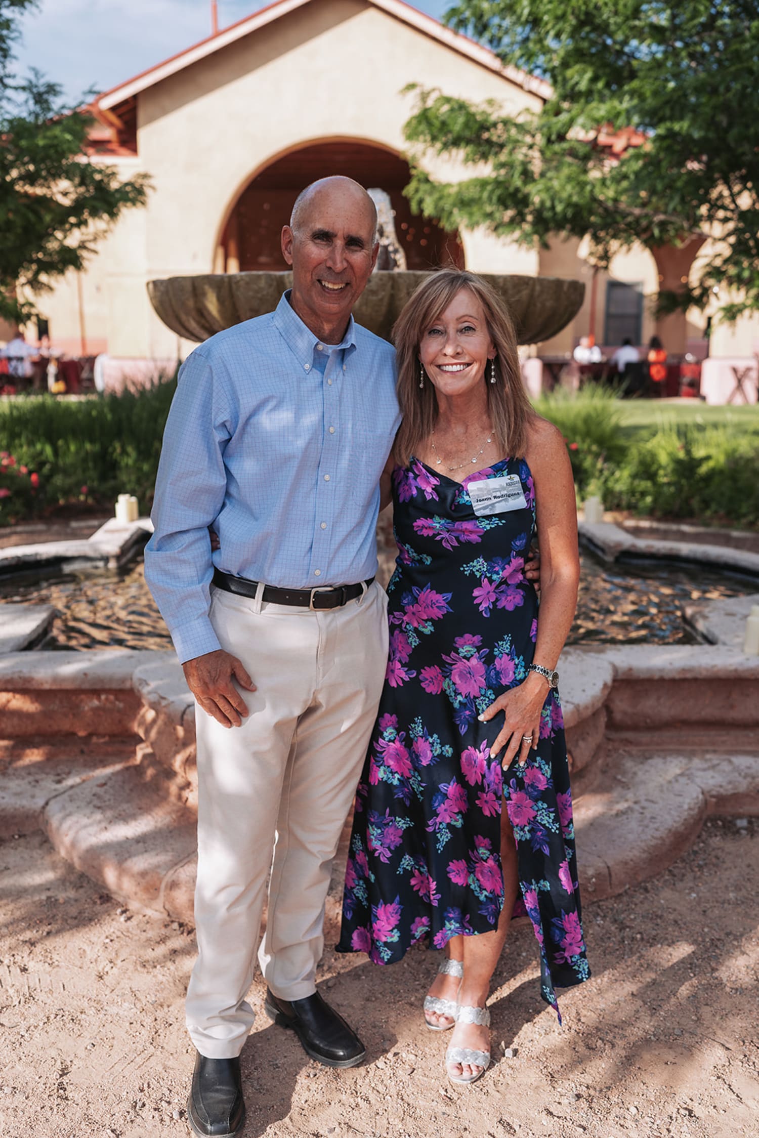 Guests at outdoor venue with Southwest adobe architecture during Albuquerque corporate gathering - Casey Addason Photography