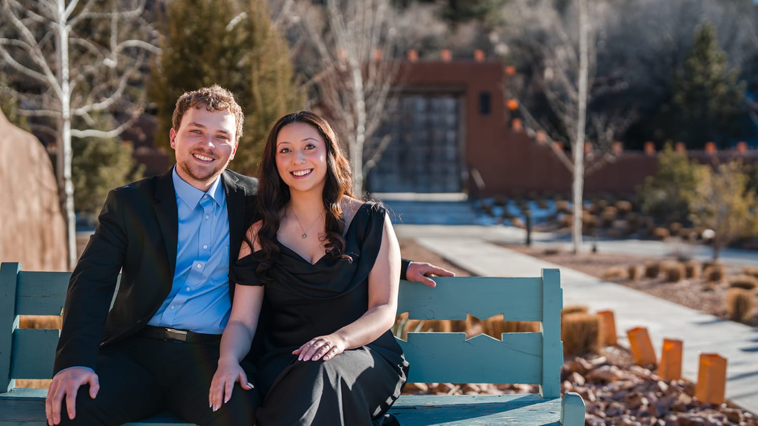 Couple on turquoise bench at rust-red Southwestern building with aspen trees, Santa Fe bridal portrait, Casey Addason Photography