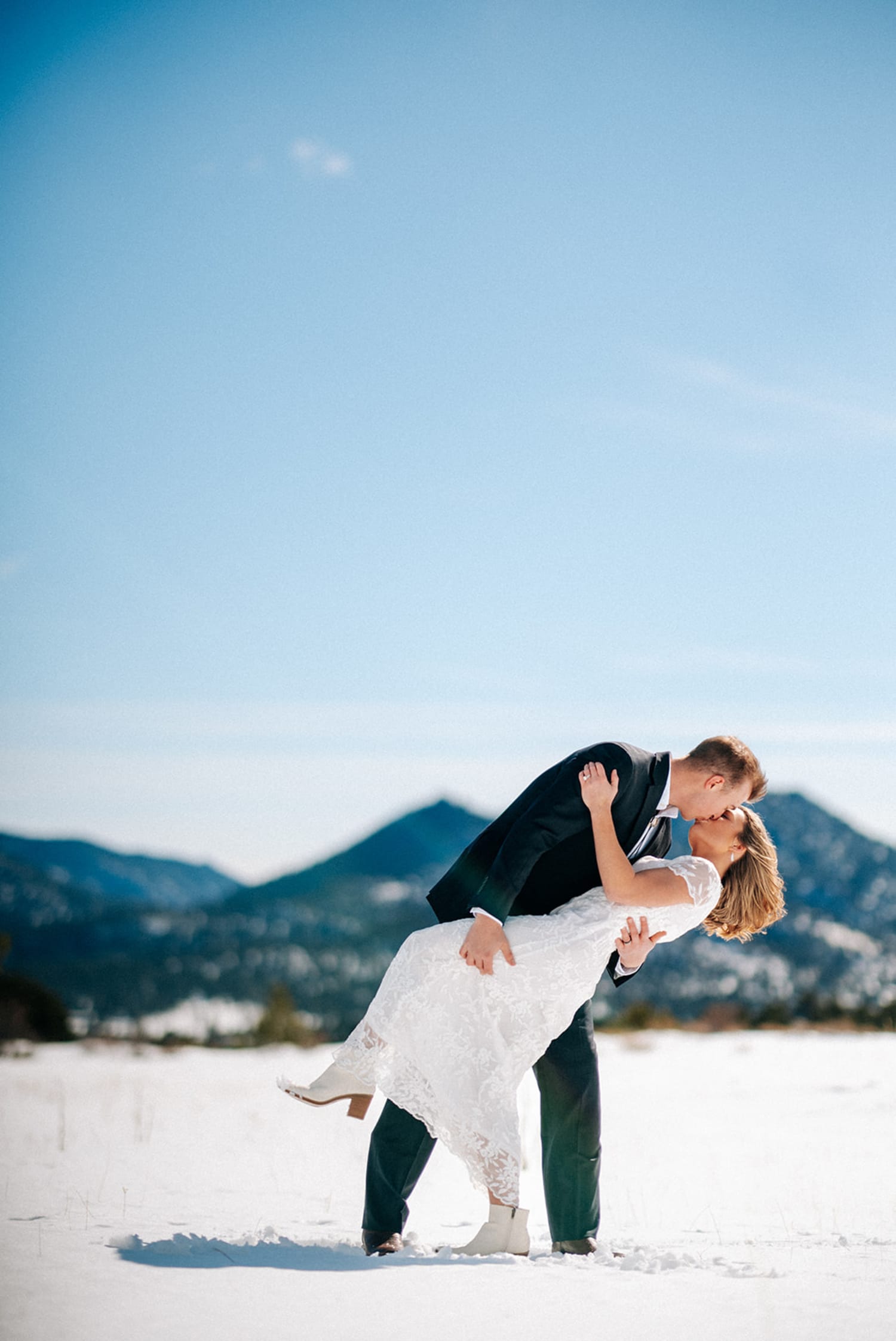 Winter elopement with bride dip in snowy mountain field near Santa Fe - Casey Addason Photography