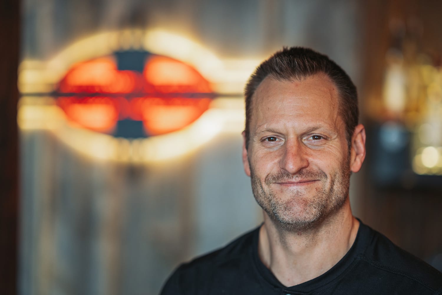 Portrait with neon signage in urban Albuquerque venue background - Casey Addason Photography
