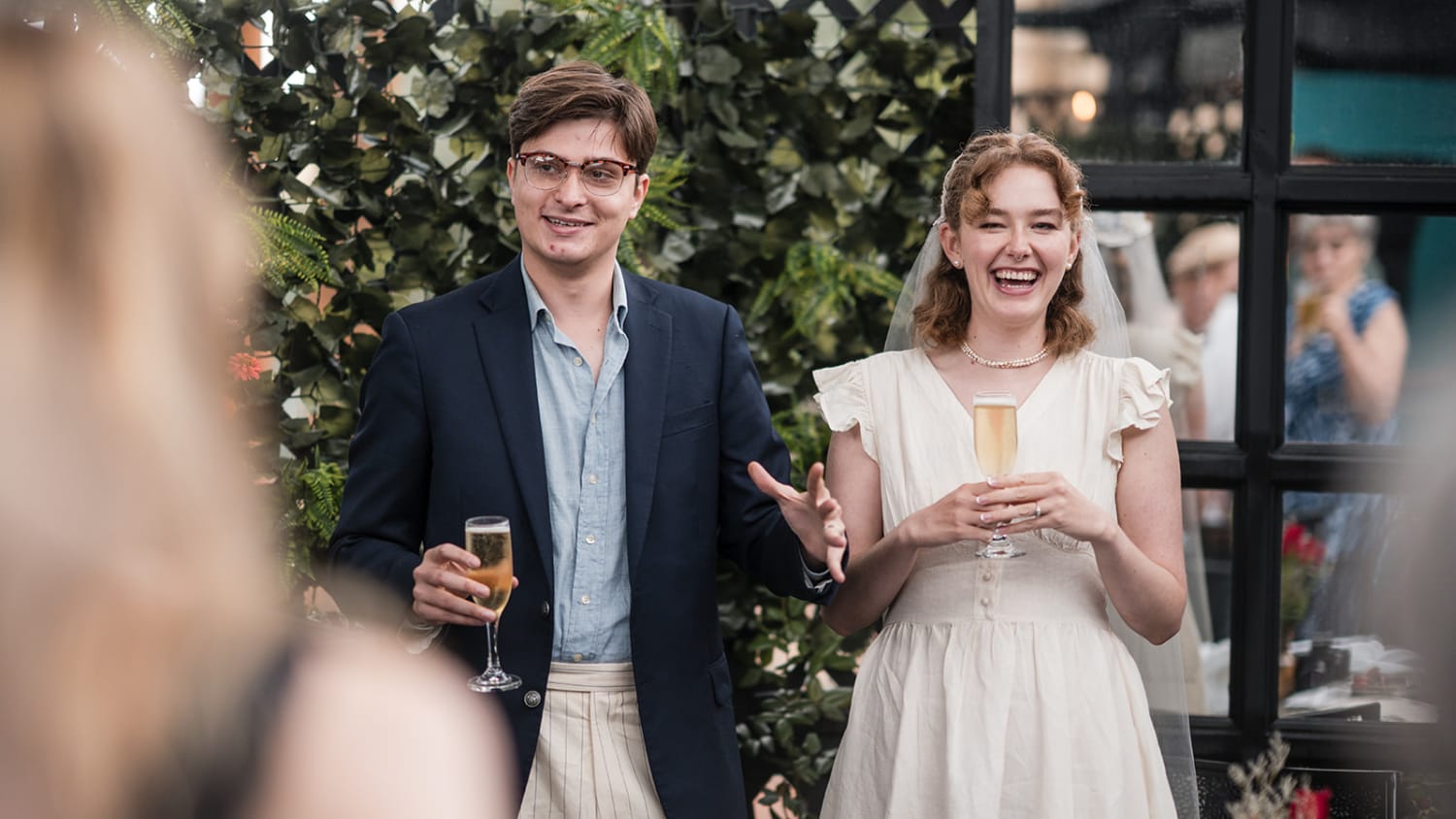 photograph documents a joyful moment during an indoor/outdoor reception held in a modern venue wit... — Casey Addason Photography