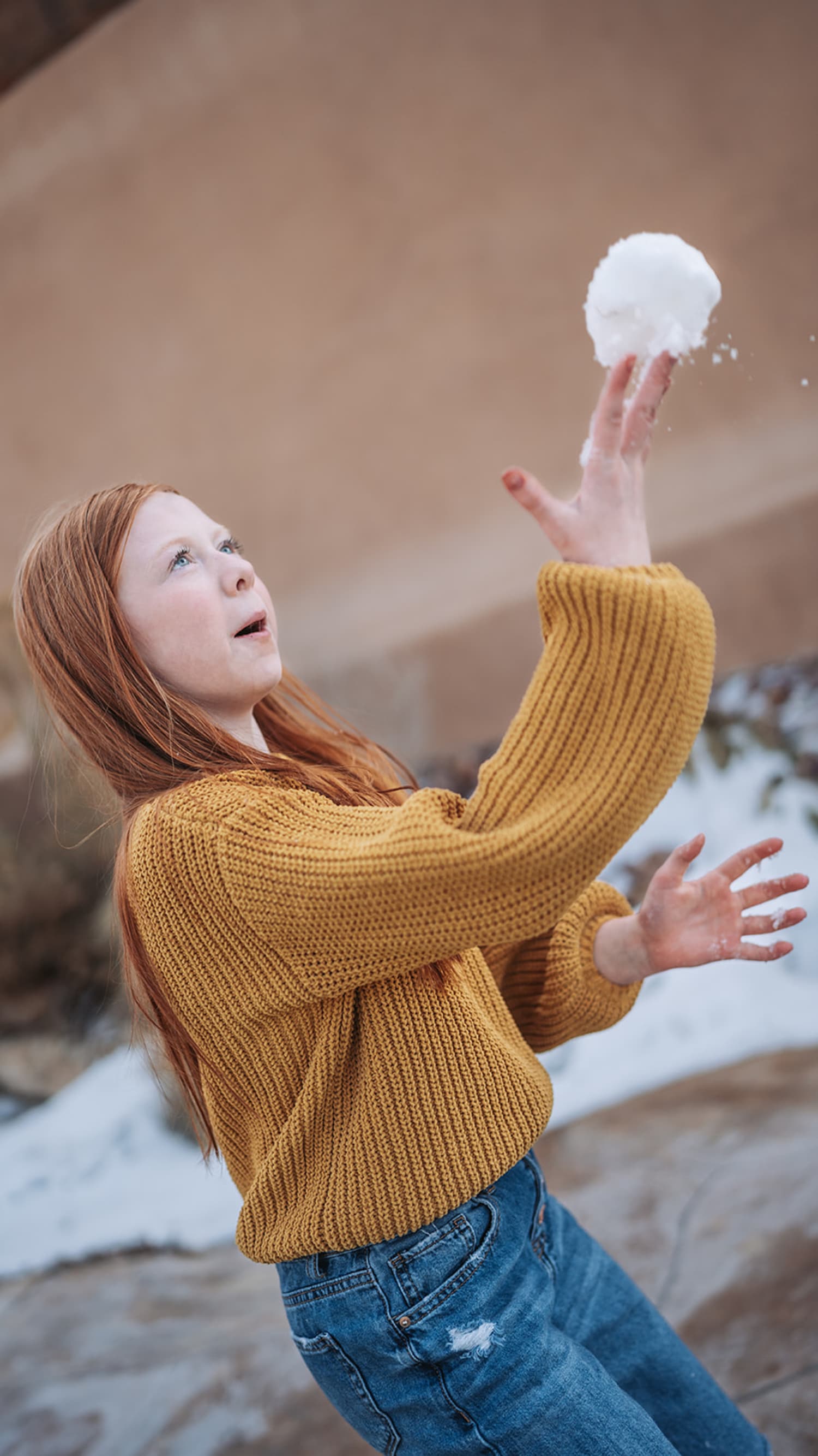 portrait documents a young woman in a candid moment at what appears to be an adobe or clay-colored... — Casey Addason Photography