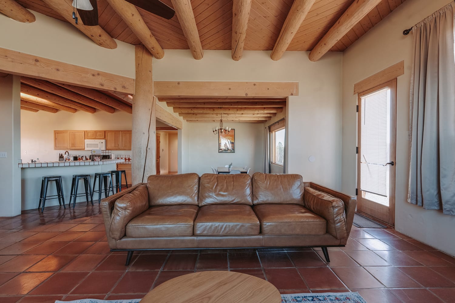 image documents a contemporary residential interior featuring exposed wooden beam ceilings and ter... — Casey Addason Photography