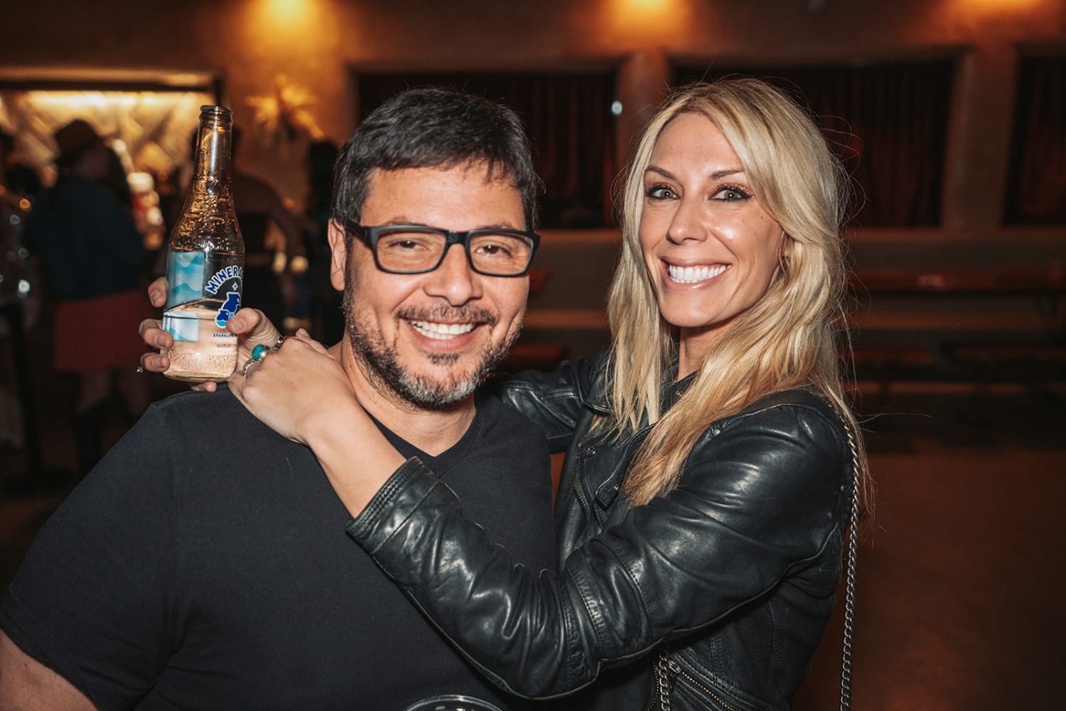 evening event documents two guests in a warmly lit venue with warm ambient lighting and golden ove... — Casey Addason Photography