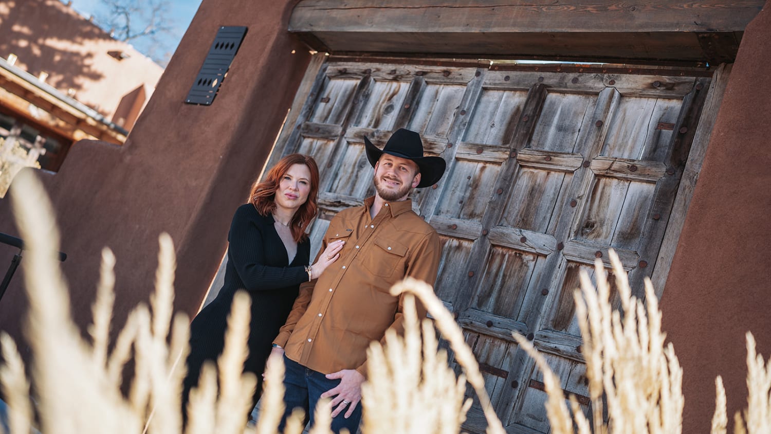 Couple walking through the Bishop's Lodge property at sunset — Santa Fe luxury wedding photographer