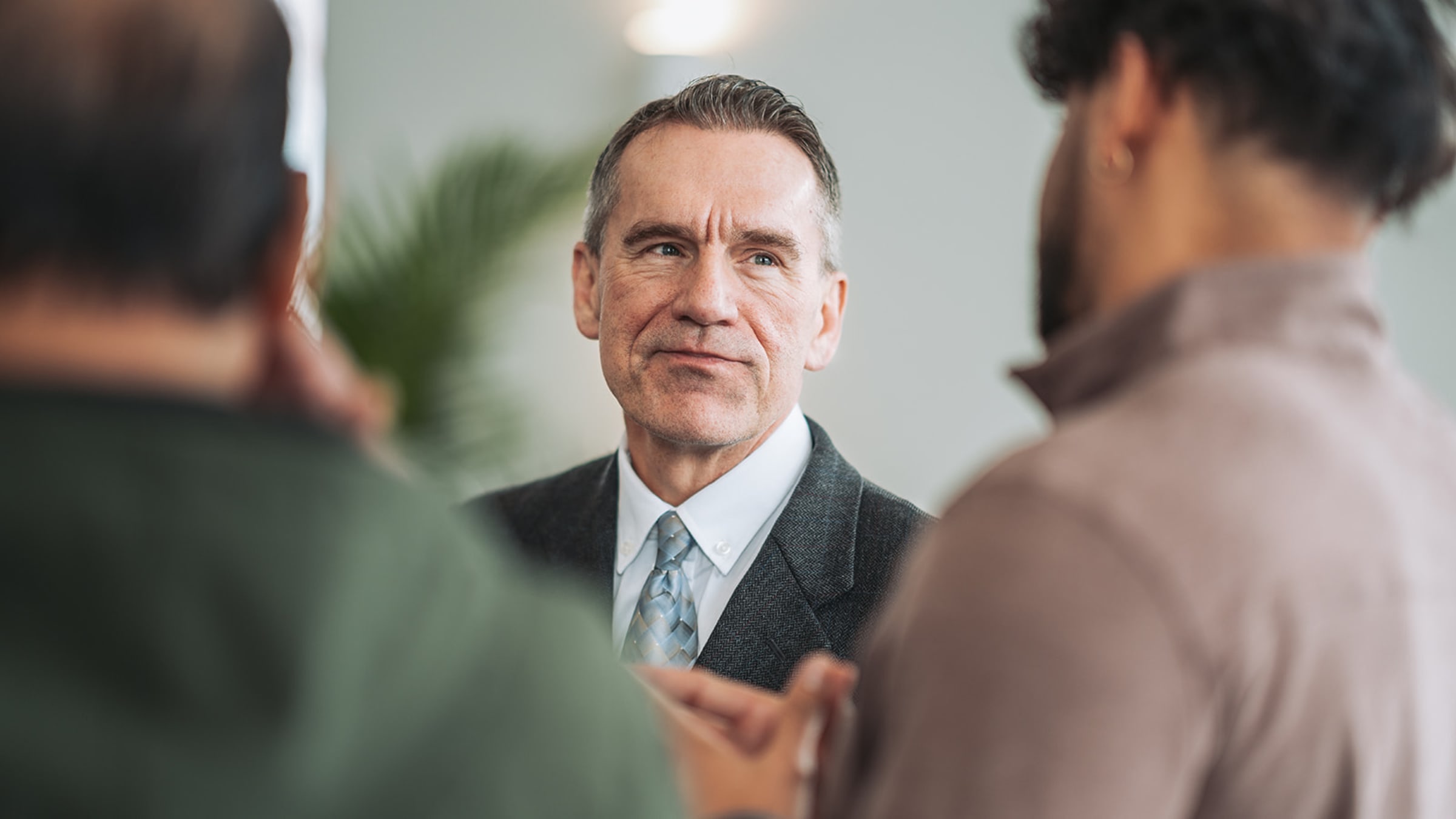 Professional in business attire at corporate event in modern office space