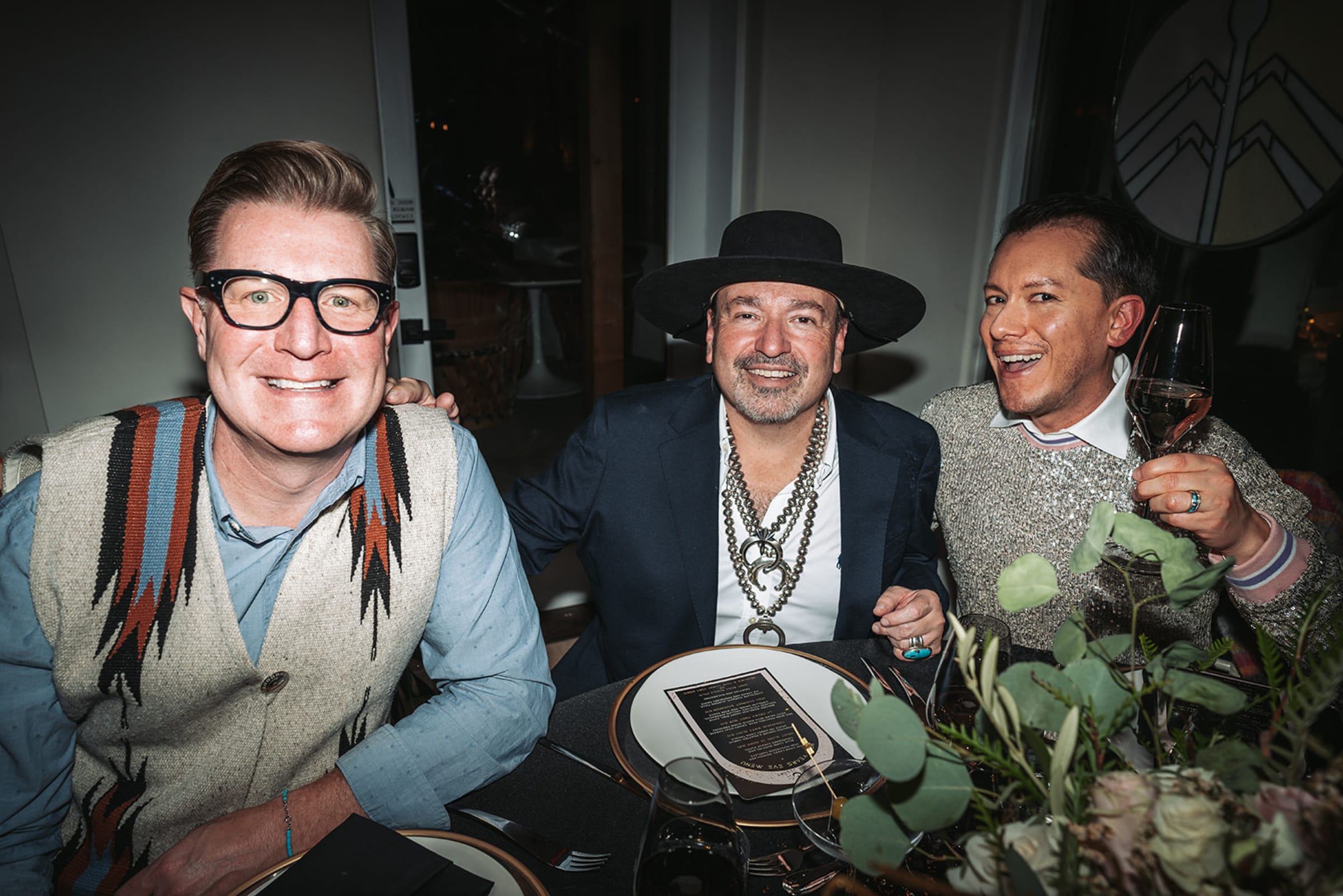 Dinner guests laughing and celebrating at New Year's Eve dinner in Santa Fe