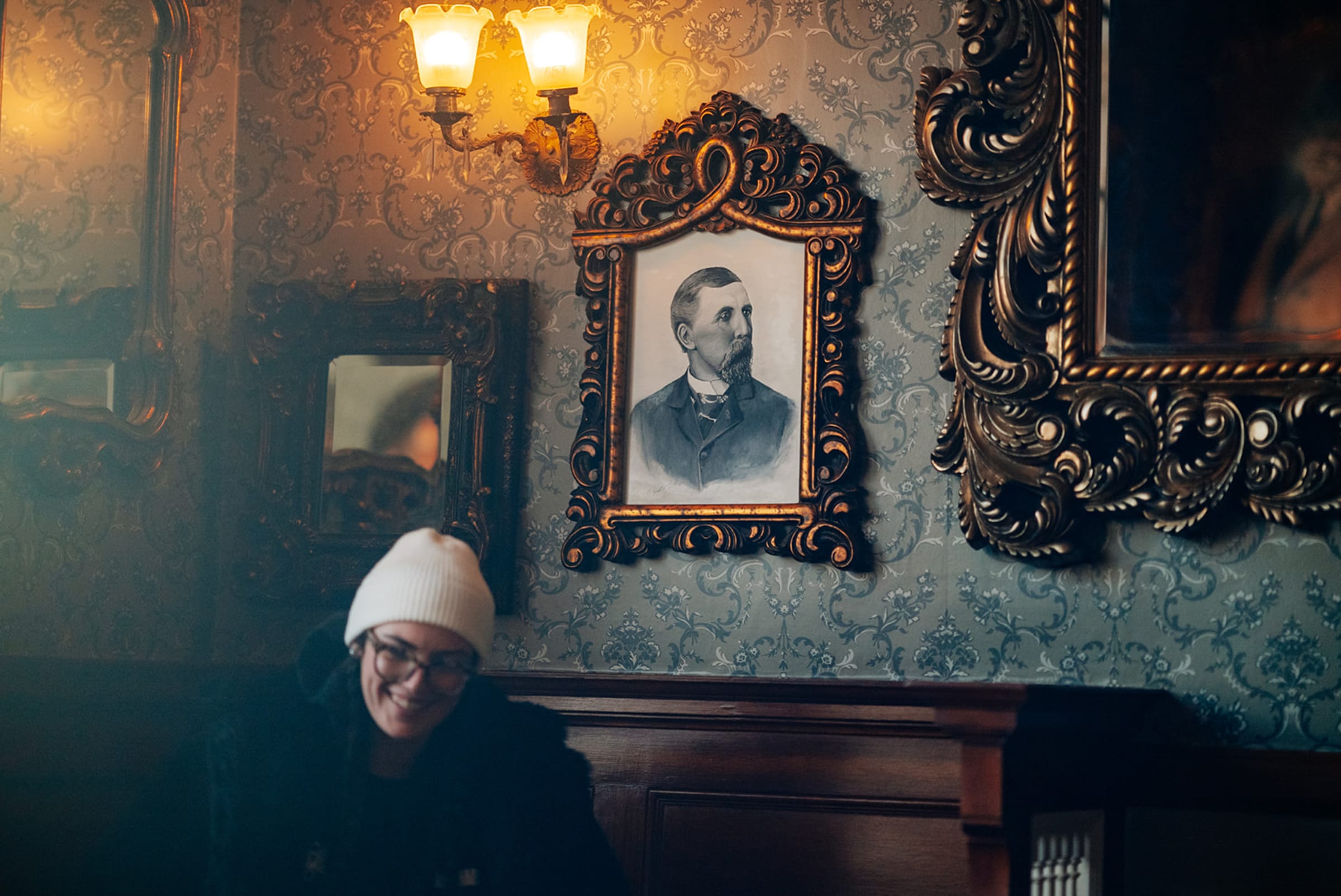 Close group portrait with Stanley Hotel columns and mountain range in the background