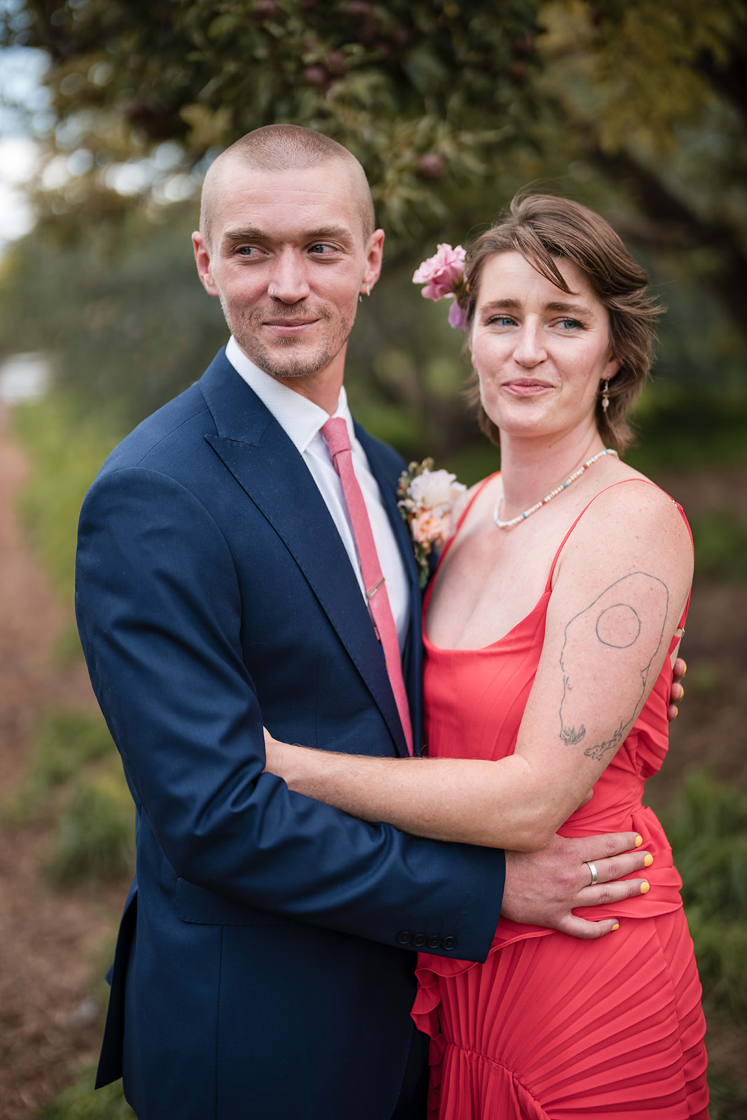 Engagement portrait at Diablo Canyon with red rock cliffs glowing copper in late afternoon light — Casey Addason Photography