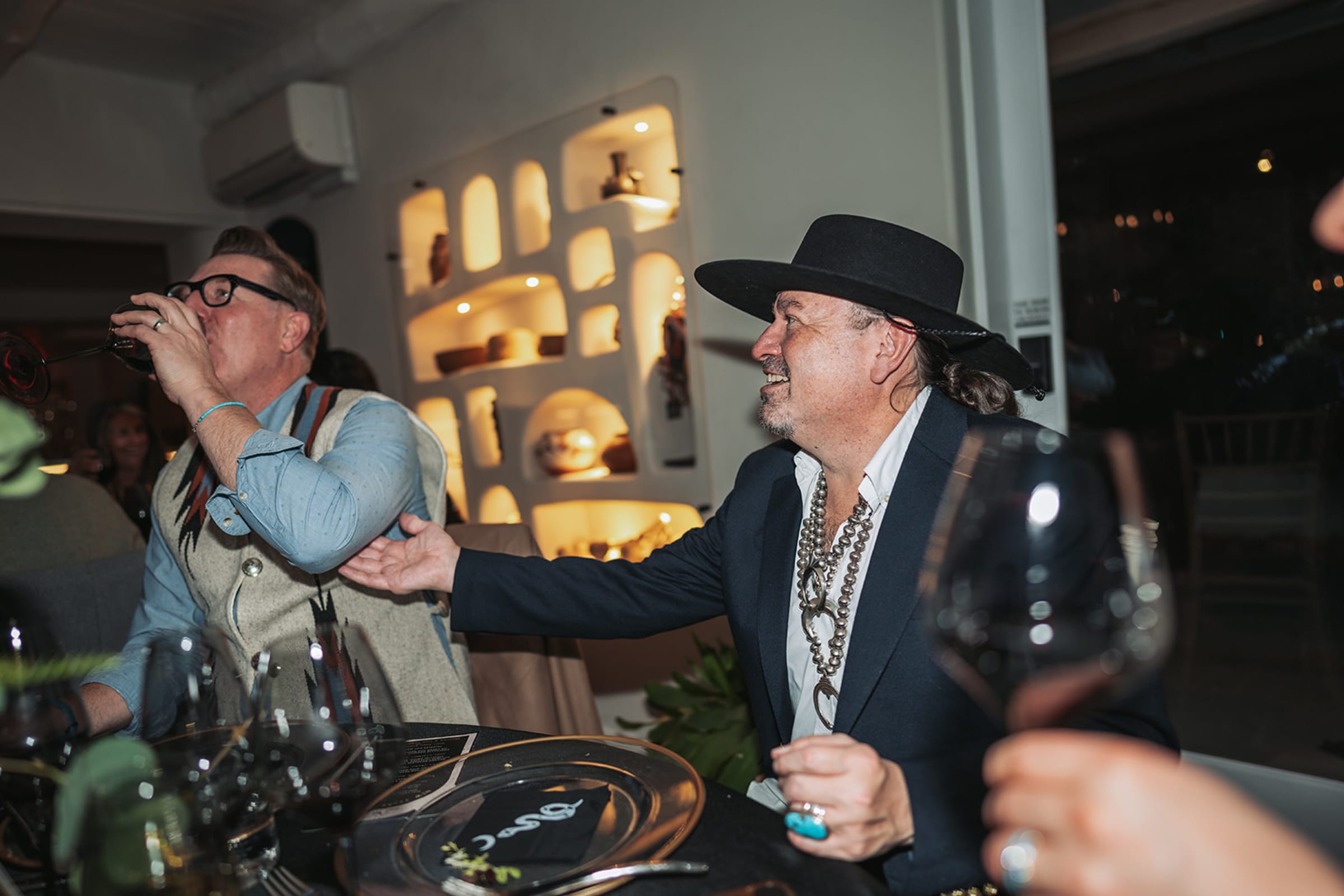 Candid photograph of friends laughing during a private dinner celebration in a Santa Fe restaurant — Casey Addason Photography