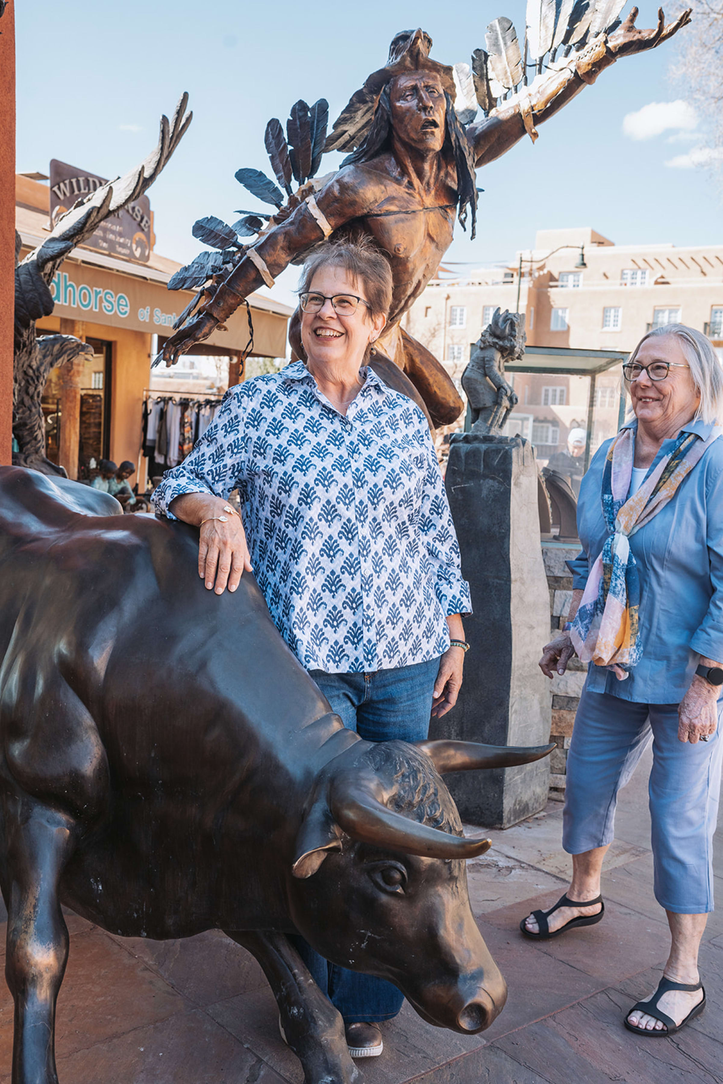Outdoor evening celebration on a Santa Fe patio with string lights and adobe walls at sunset — Casey Addason Photography