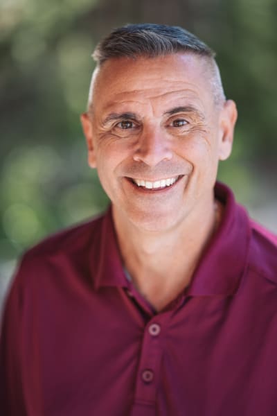 Natural light headshot at Bishop's Lodge, Santa Fe, burgundy polo — Casey Addason Photography