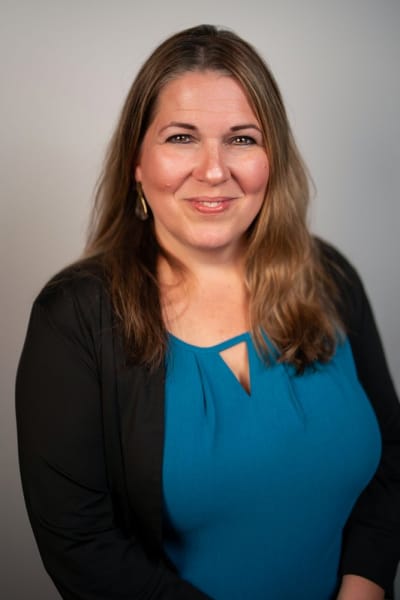Headshot on a grey backdrop, teal top — Casey Addason Photography