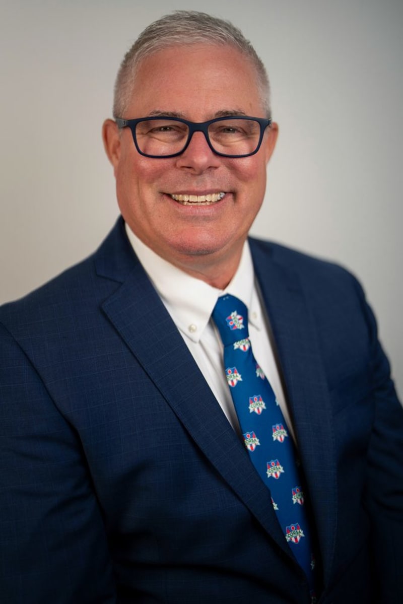 Backdrop headshot, navy suit