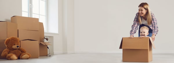 nainen, lapsi ja pahvilaatikoita