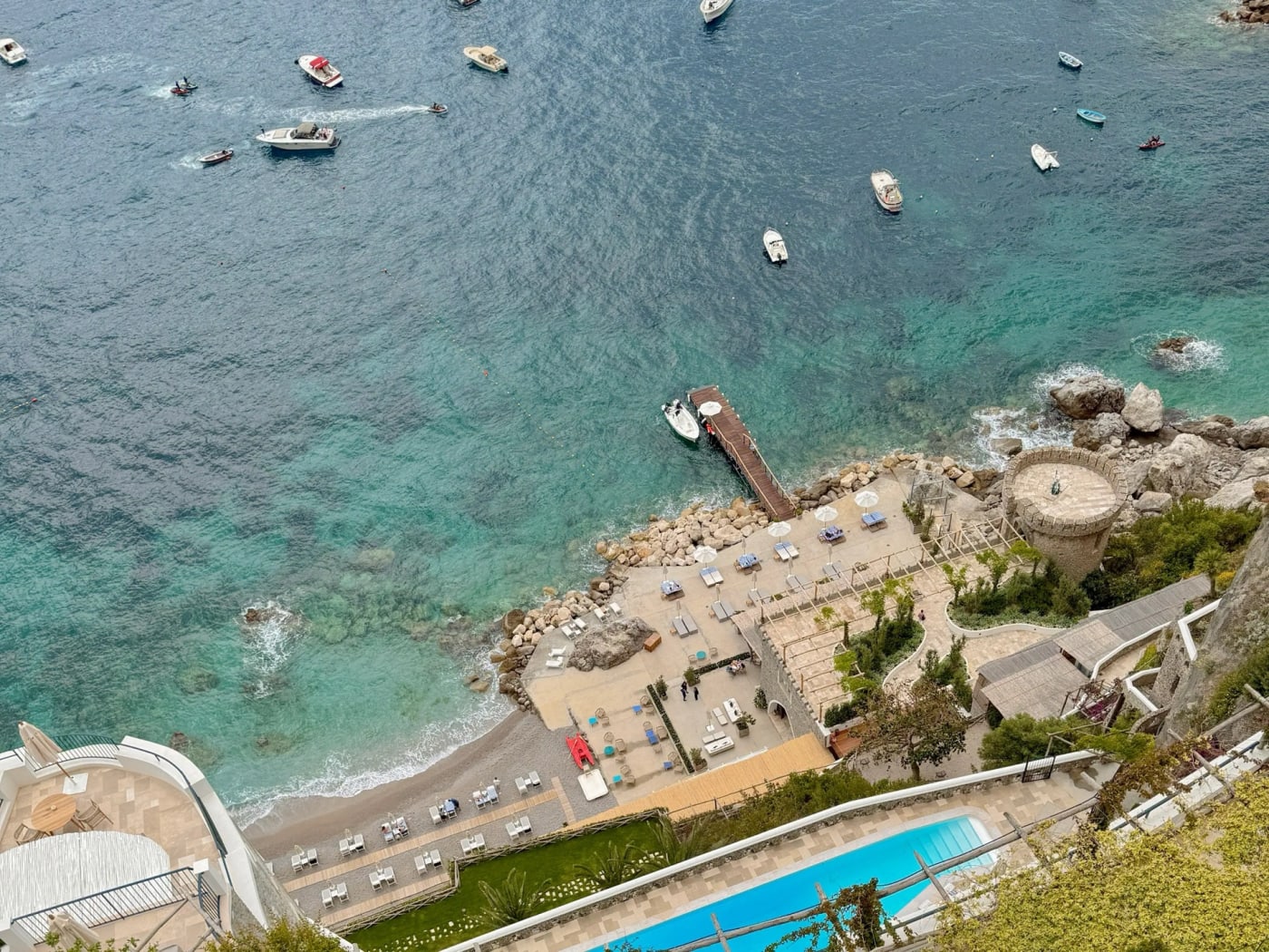 Aerial view of the pools, jetty and beach of Borgo Santandrea on the Amalfi Coast