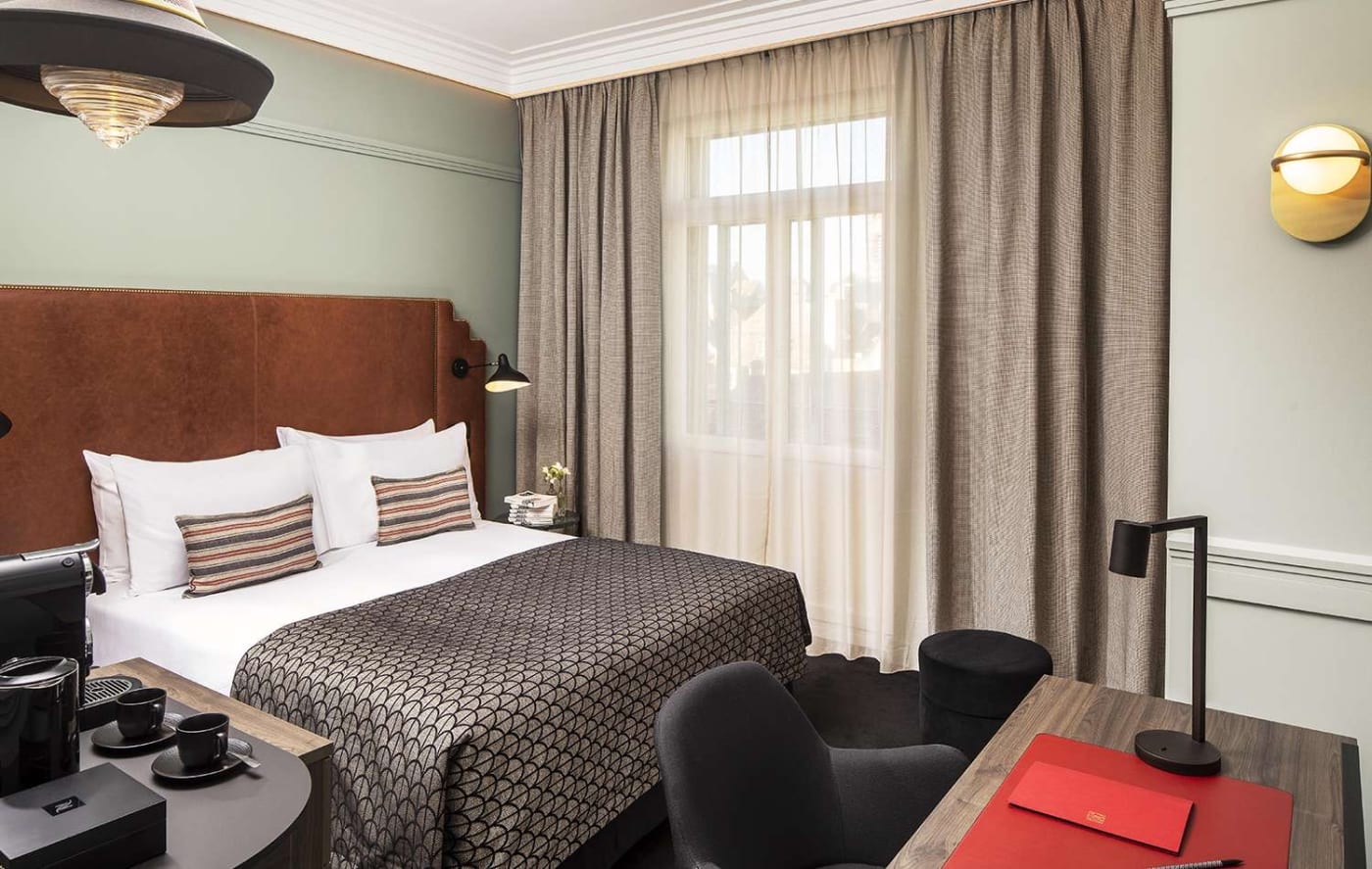 A Superior room at the Maison Rouge, desk and windows overlooking the street