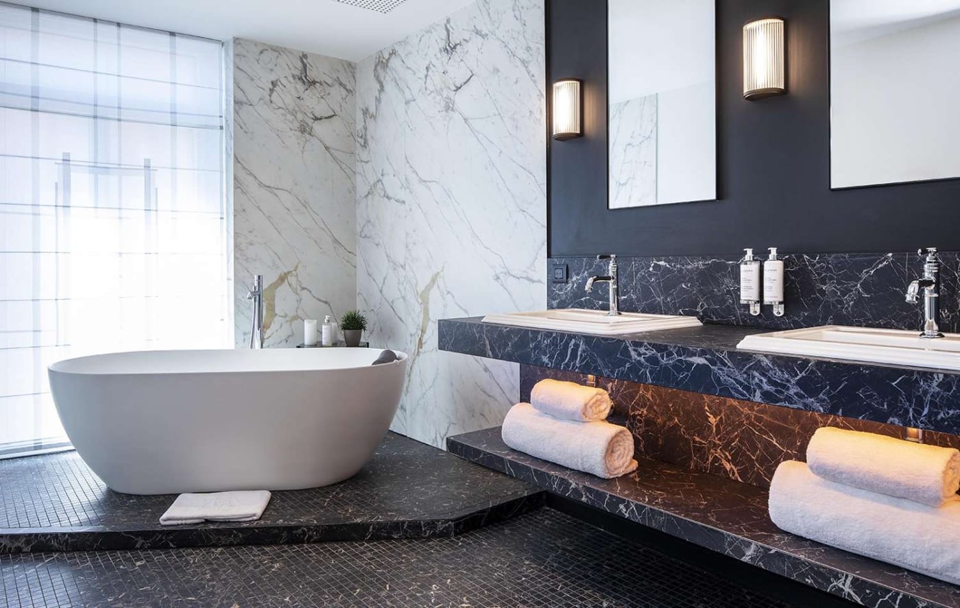 The bathroom of a suite at the Maison Rouge, freestanding bathtub and double vanity