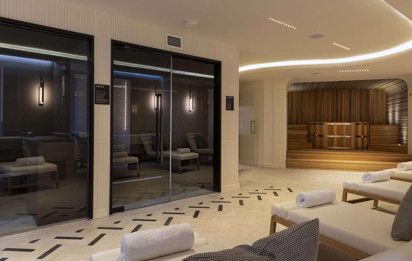 The relaxation area of the Maison Rouge spa, glass-walled hammam and sauna