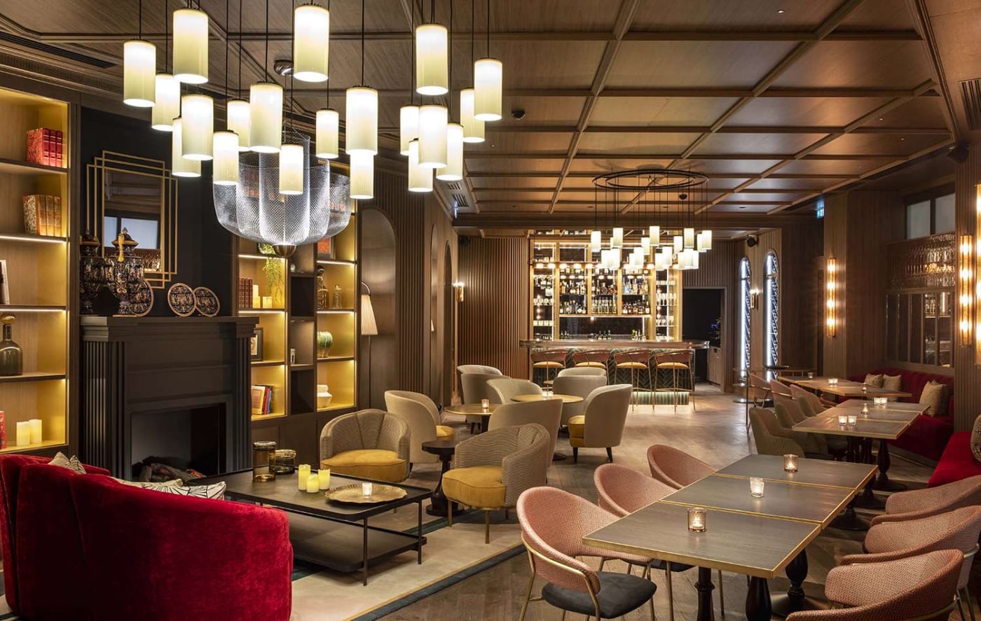 The dining room of Le 1387 restaurant, chandeliers and bookcases