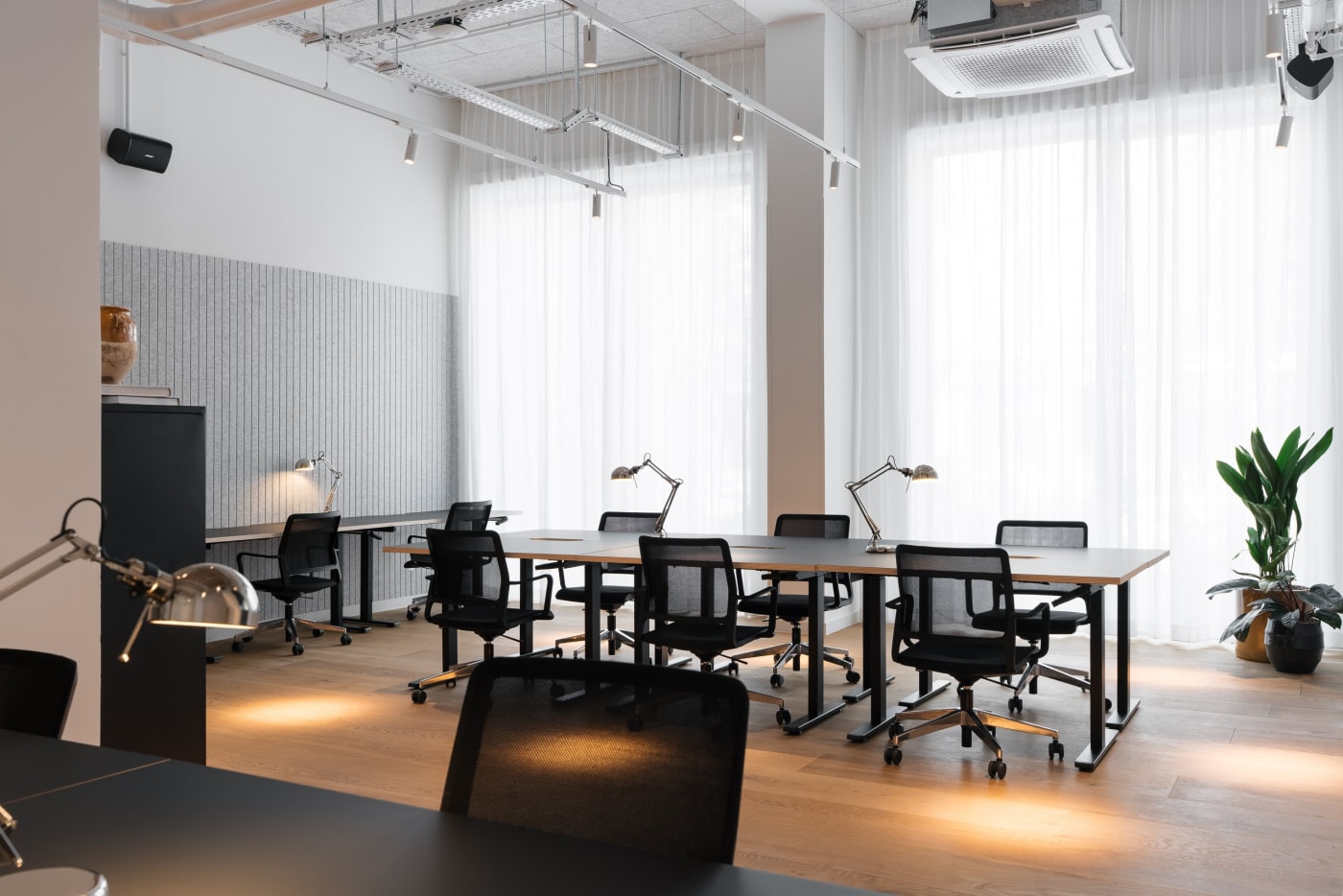Dedicated workstations at the Ruby Yani coworking in Marseille, shared desks and architect lamps