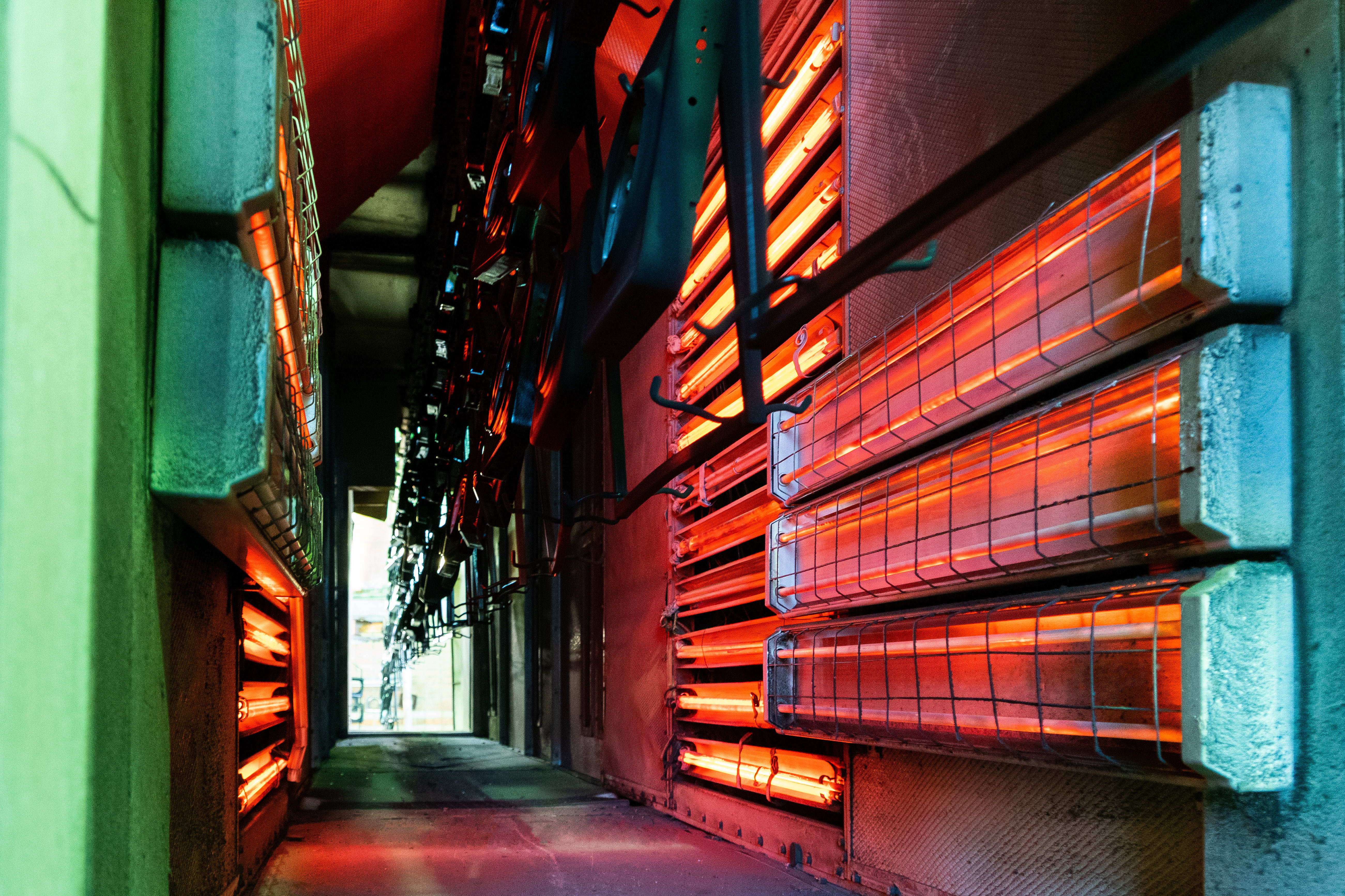 Production workshop for drying parts in the oven on a conveyor belt