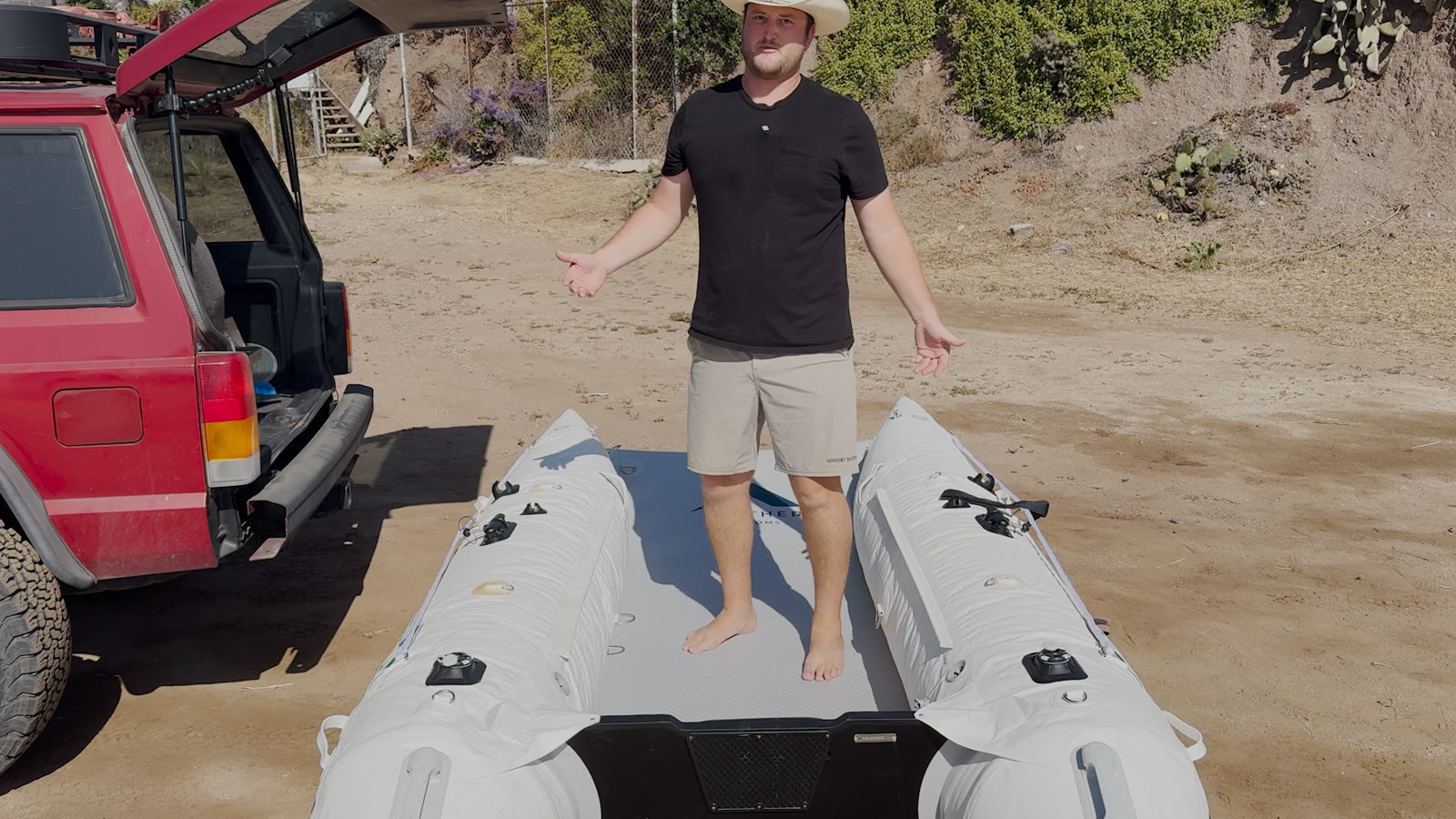 Modern inflatable tender fully set up with its rigid drop-stitch floor in a parking lot, ready to launch
