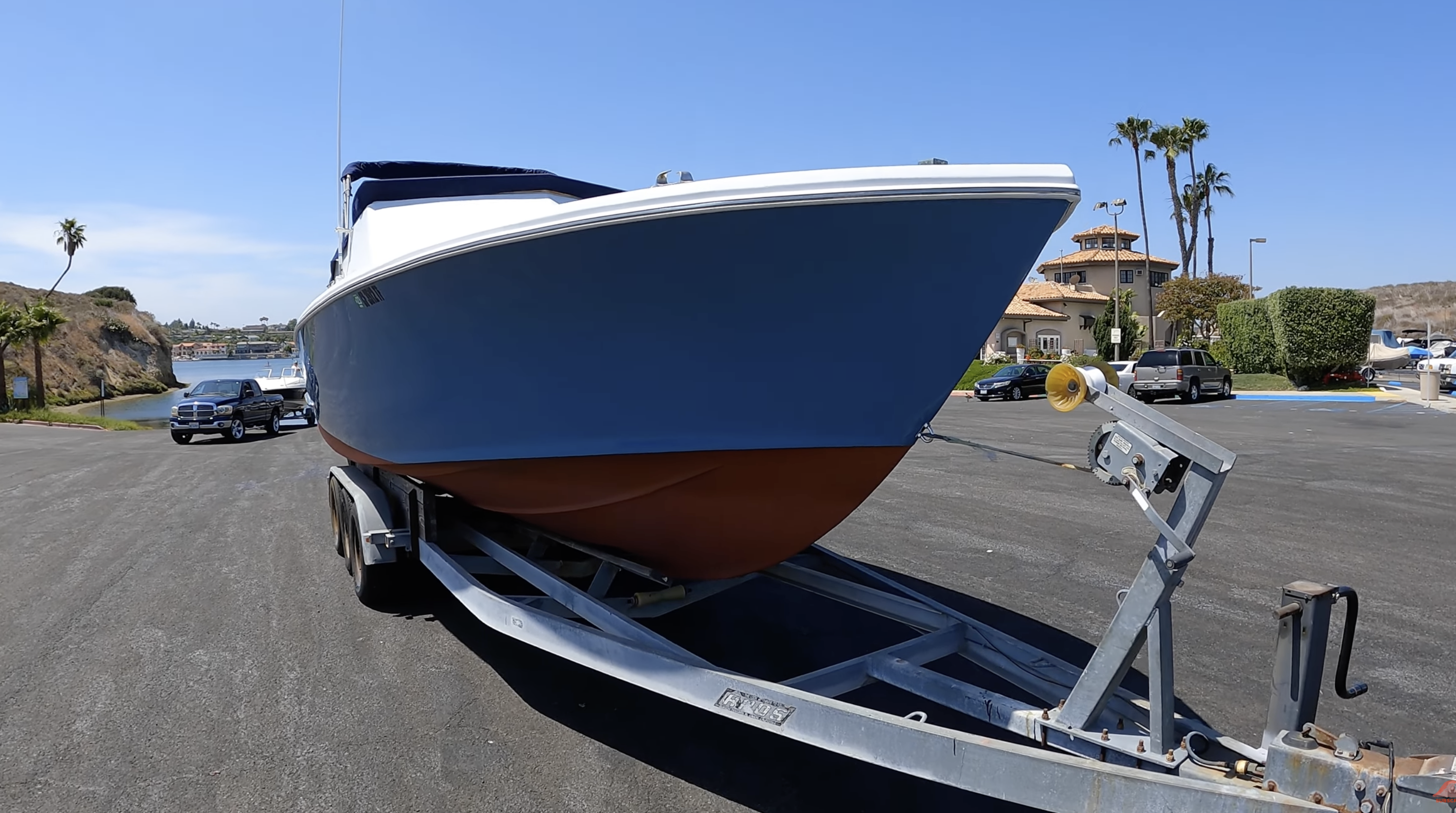 Crystaliner 29.5 deep-V hull profile on its trailer at the boat ramp
