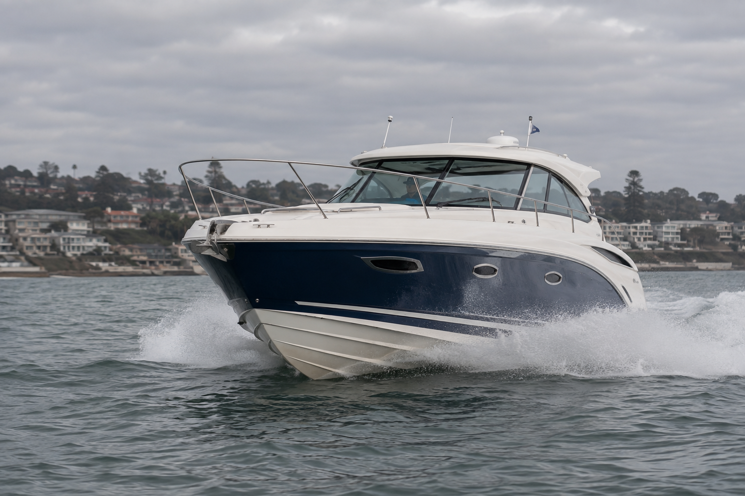 Powerboat running level and dry through light chop with spray off the bow