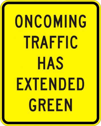 Oncoming Traffic Has Extended Green Sign - W25-1