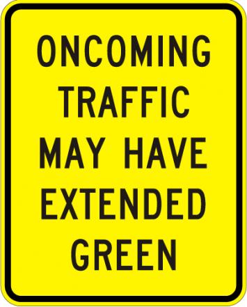 Oncoming Traffic May Have Extended Green Sign - W25-2