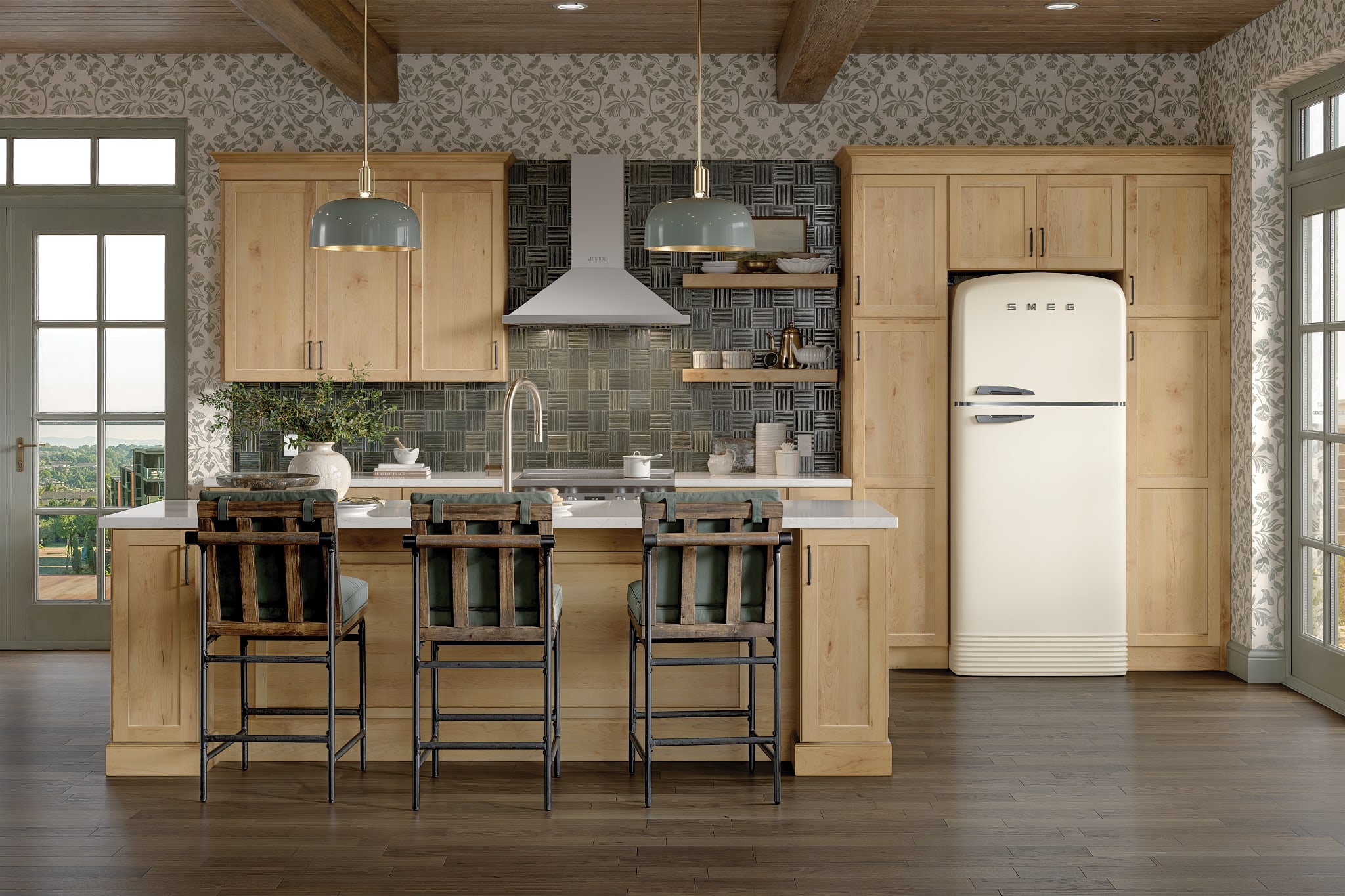 Modern kitchen interior with natural wood ceiling beams, gray upper cabinets and beige lower cabinets, swirling stone countertop and backsplash, a stainless-steel range with hood, and a wooden dining table with upholstered chairs beside large black-framed windows.