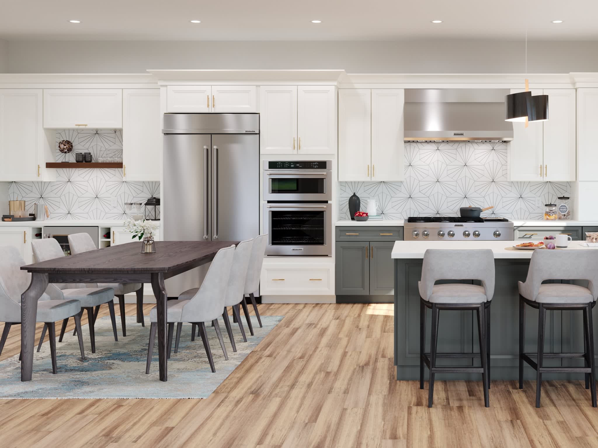 Bright white kitchen with shaker-style cabinets, a spacious island topped in white marble, stainless-steel range and hood, a linear glass-shaded chandelier, open shelves holding dishware and décor, a wall clock, and light wood floors illuminated by large windows.