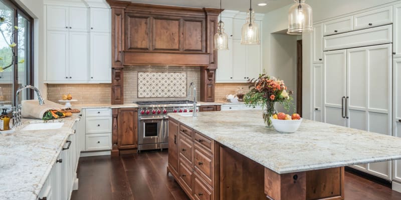 Brown dark stained traditional cabinets in a white kitchen