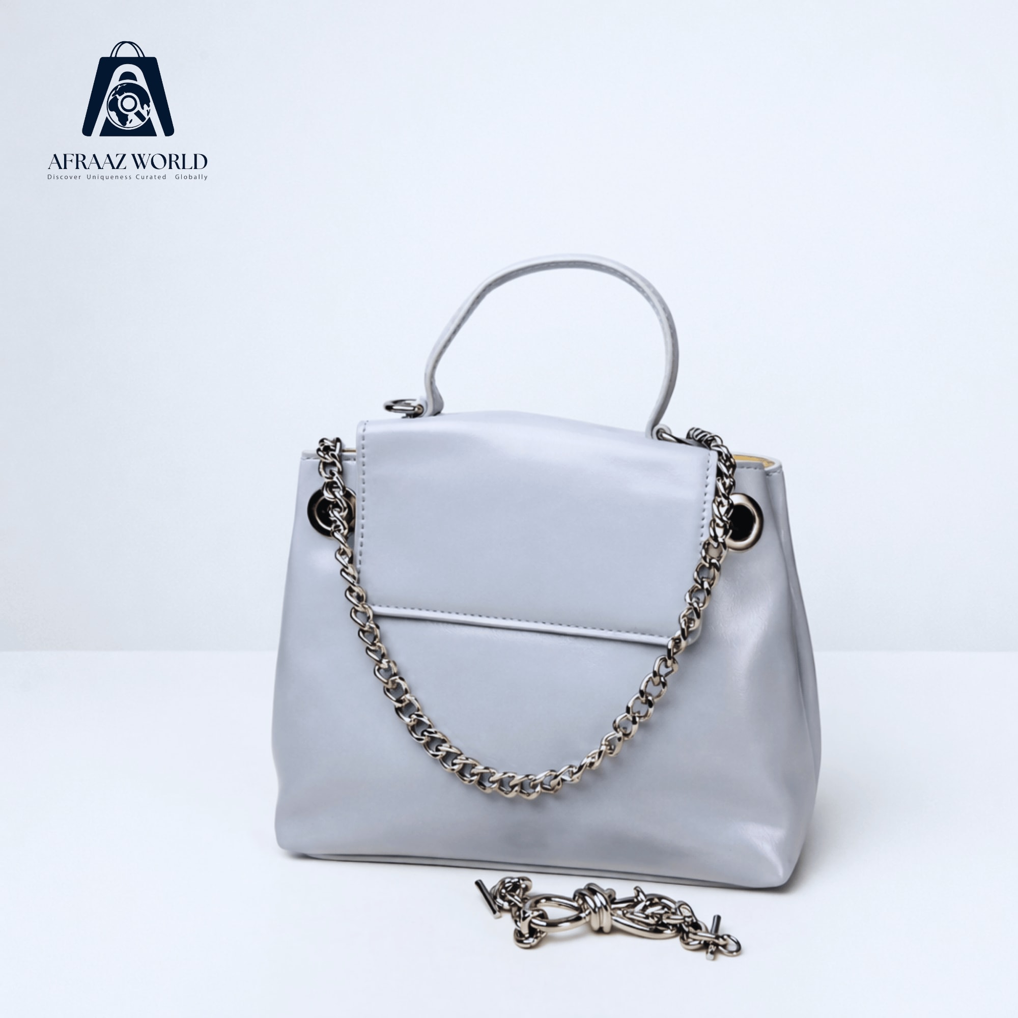 High-Shine Minimalist Handbag with Industrial Eyelet Accents