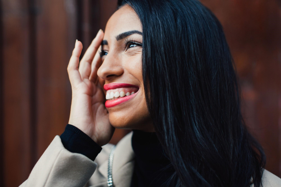 How long does it take for injectable wrinkle reducers to work? | Spotlyte portrait of a smiling stylish woman in the street