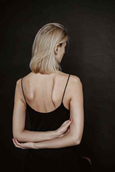 What to expect at a routine skin check Woman wearing tank top with her back to the camera