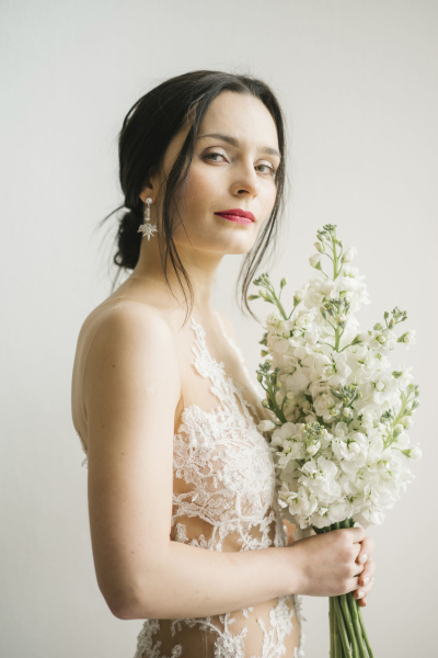 When to get treatments before your wedding Bride holding bouquet of flowers