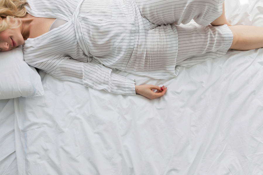 Tips to look less tired Woman lying in bed