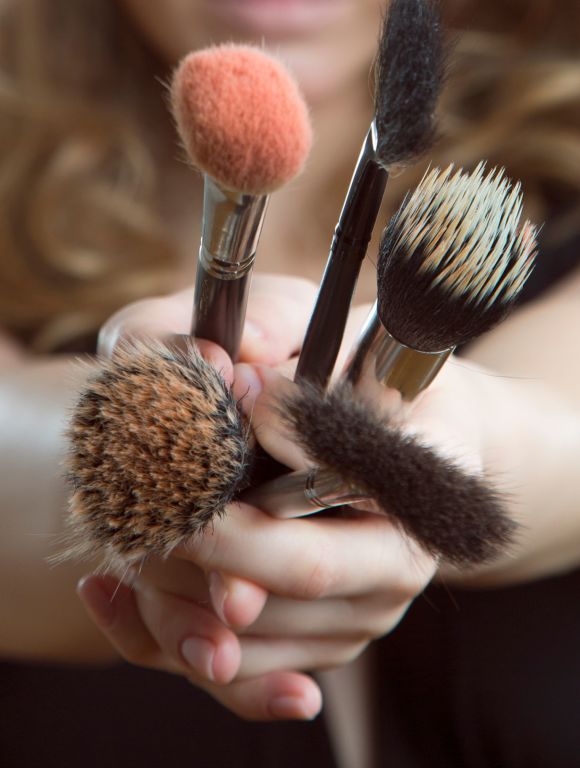 Handful of makeup brushes