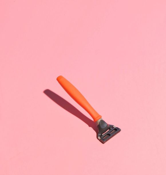 orange razor on pink background