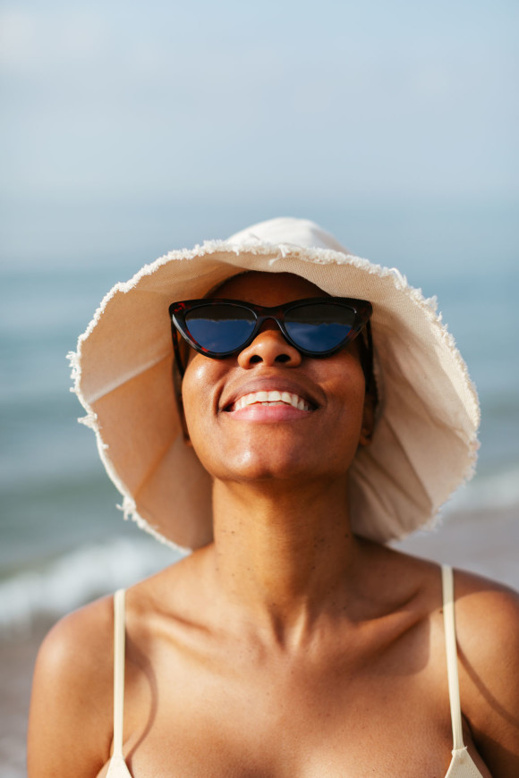 Black woman in sunglasses smiling