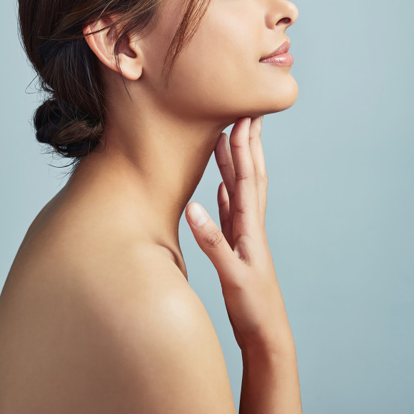 Woman touching her face and neck