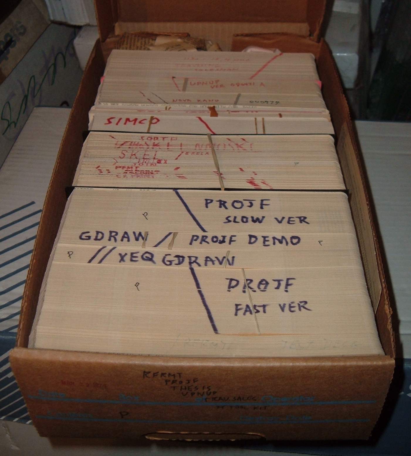 drawer full of computer programs stored on punch card decks